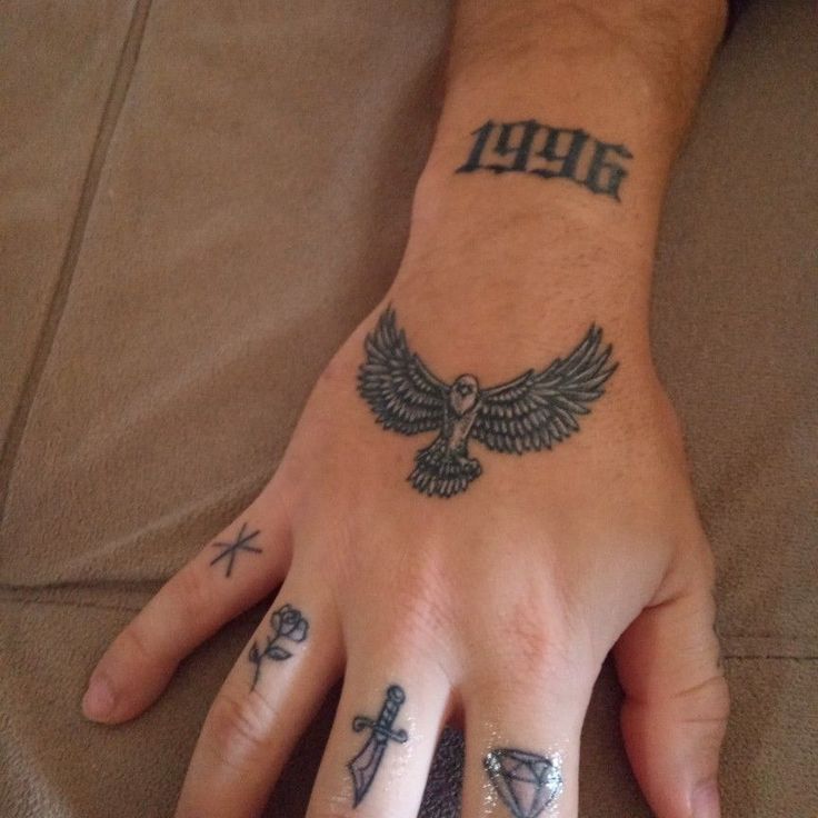 a person with tattoos on their hands and fingers