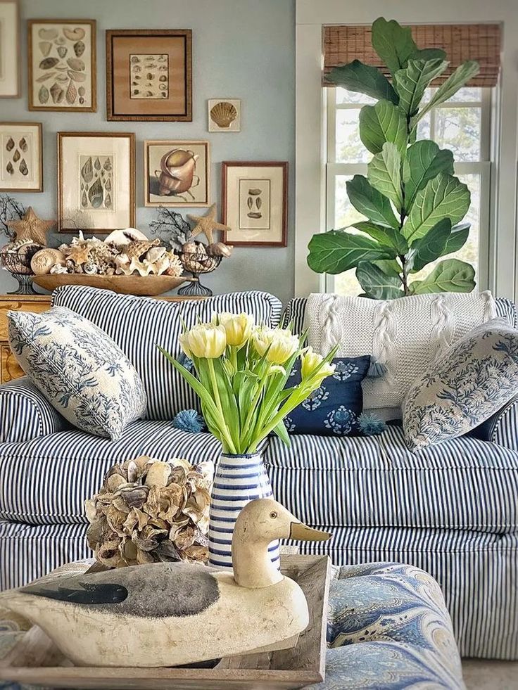 a living room filled with furniture and flowers in a vase on top of a coffee table