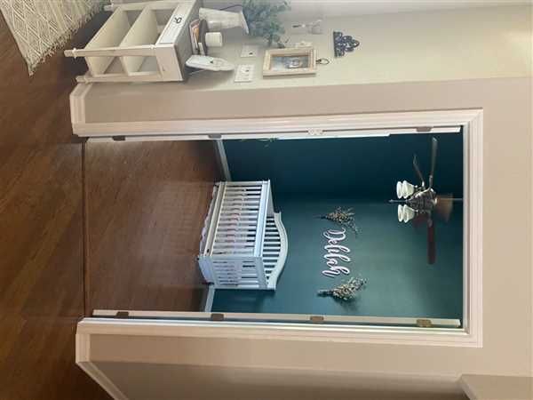 an open window shows the inside of a room with various items in it and on the floor