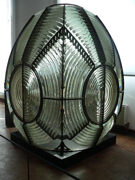 a large glass object sitting on top of a wooden floor