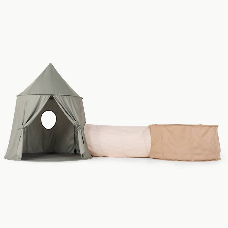 a tent and pillow set up on the floor