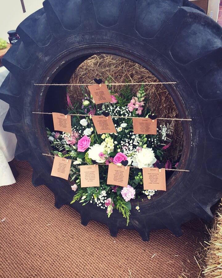 there is a large tire with flowers on it and some tags attached to the tires