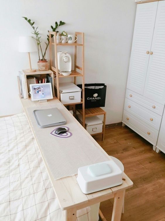 a bed room with a laptop on top of it