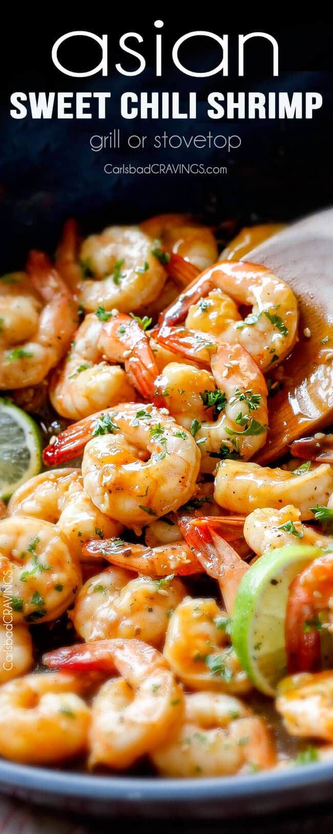 a close up of a plate of food with shrimp and limes on the side