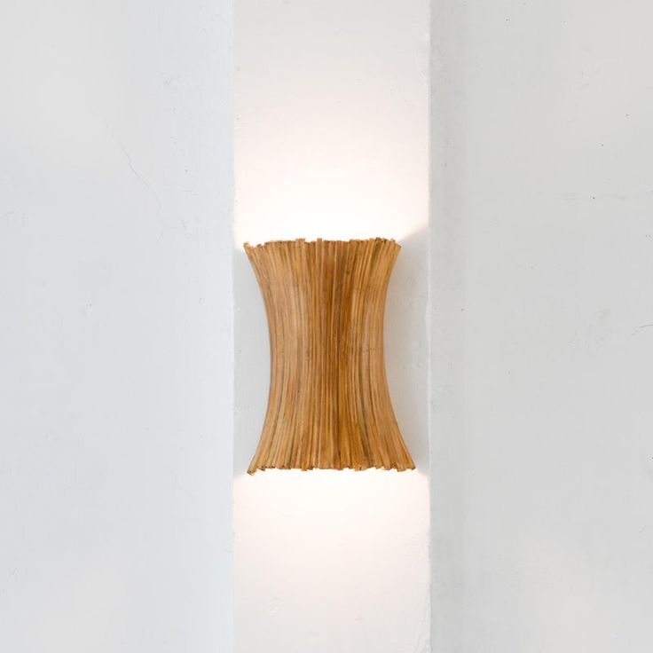 a light that is on the side of a wall with a wooden object in it