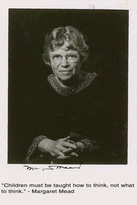 an older woman with glasses is holding her hands together and looking at the camera, in black and white