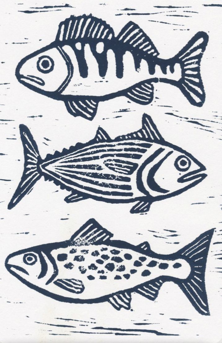 three fish are shown in black and white on a piece of paper that has been drawn