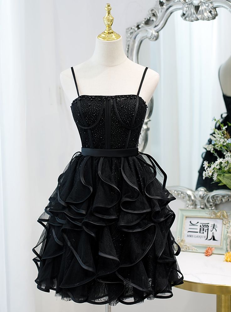 Pristinely presented, this dress is a vision in black, perfect for the young woman with a taste for the timeless. The bodice's delicate shimmer, coupled with the layered tulle skirt's cascading ruffles, evokes the classic ballerina aesthetic with a contemporary twist. The dress's silhouette, both flattering and feminine, promises to turn heads and captivate attention throughout the homecoming festivities. Simple Party Dress, Prom 2022, Dama Dresses, Professional Dress, Cheap Homecoming Dresses, Tulle Homecoming Dress, Homecoming Dresses Black, Short Homecoming Dress, Short Prom Dress