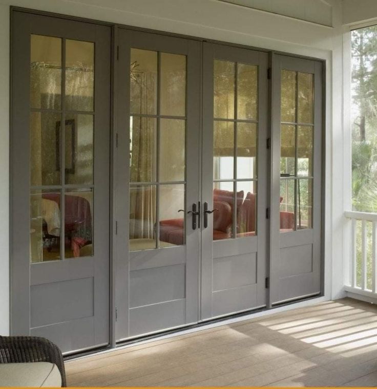 the sun shines through the windows onto an empty porch with french doors on both sides