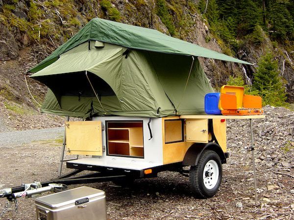 a trailer with a tent attached to it