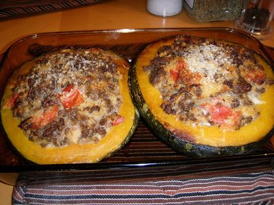 two pizzas sitting on top of a pan covered in cheese and meat toppings