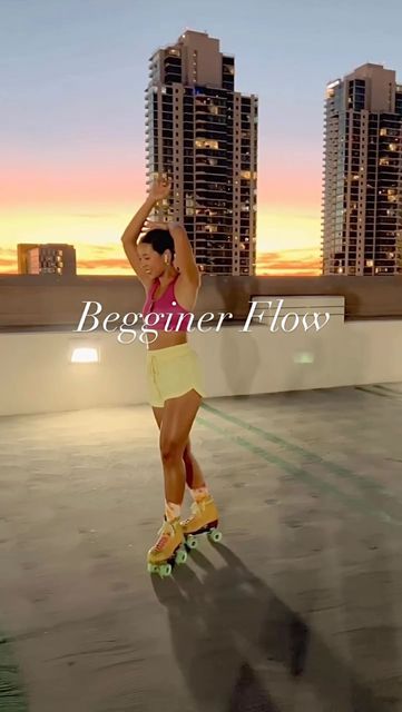 a woman riding a skateboard on top of a roof in front of tall buildings