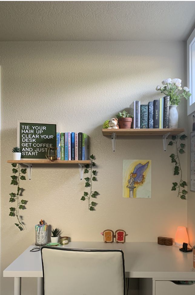 a white desk topped with two shelves filled with books