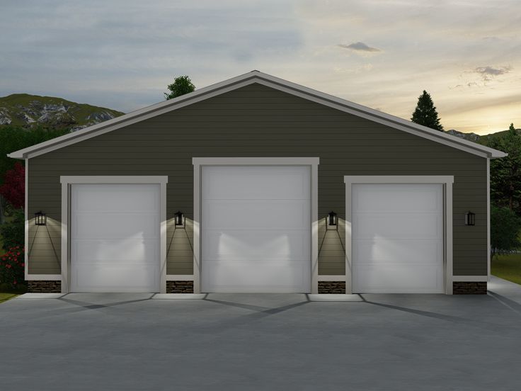 two garages with three doors open in front of a mountain range at sunset or dawn