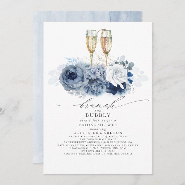 a wedding card with two champagne glasses and flowers on the front, in blue tones