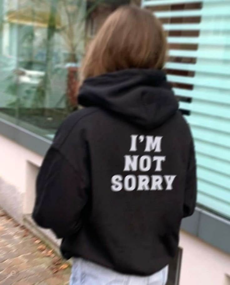 the back of a person wearing a black hoodie that says i'm not sorry