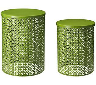 two green metal canisters sitting next to each other on a white background,