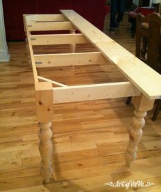 a wooden bench sitting on top of a hard wood floor