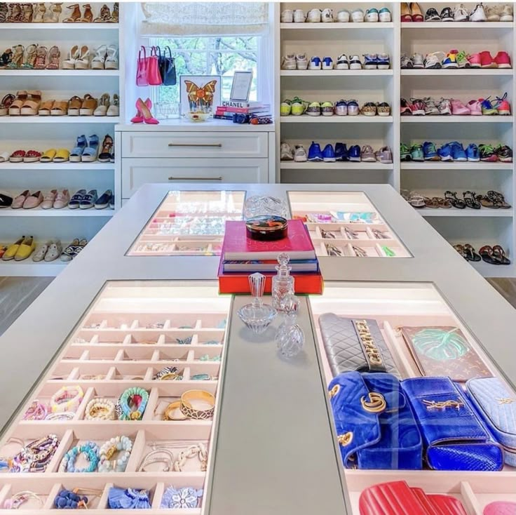 a room filled with lots of different types of shoes and purses on top of shelves