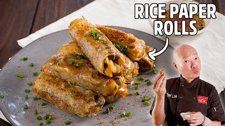 a man standing in front of a plate of food with rice paper rolls on it