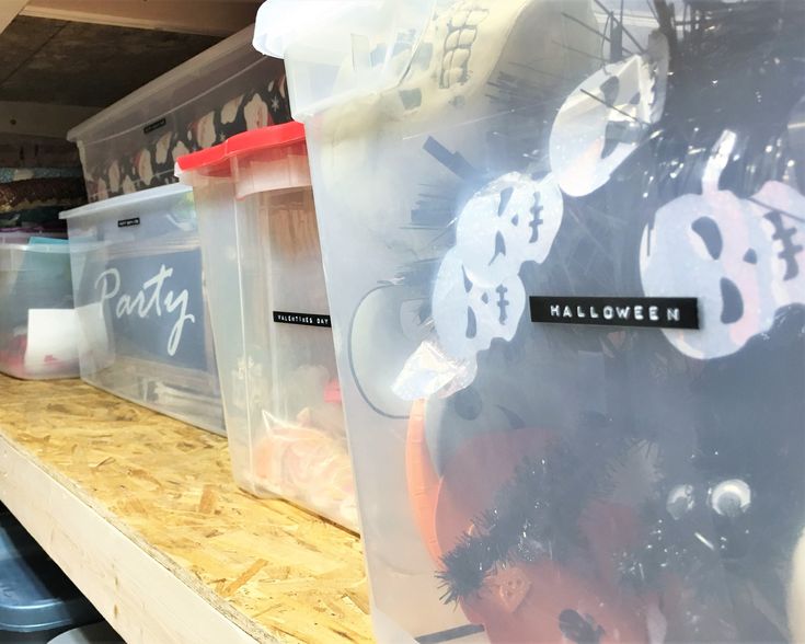 plastic containers are lined up on the shelves in a store, some with halloween decorations