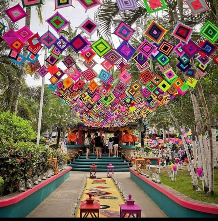 an outdoor event with colorful decorations hanging from the ceiling