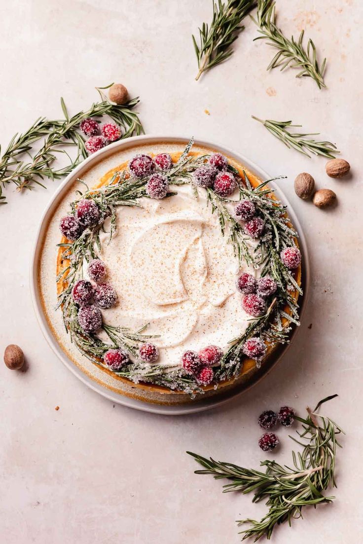 a cake with white frosting surrounded by flowers and nuts