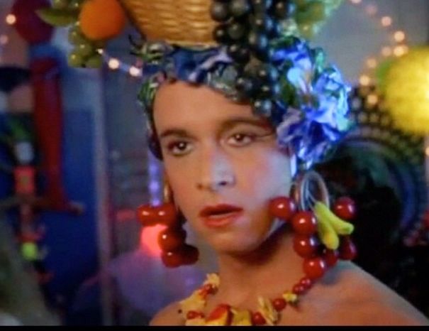 a woman with fruit on her head in a scene from the television show that's about to happen