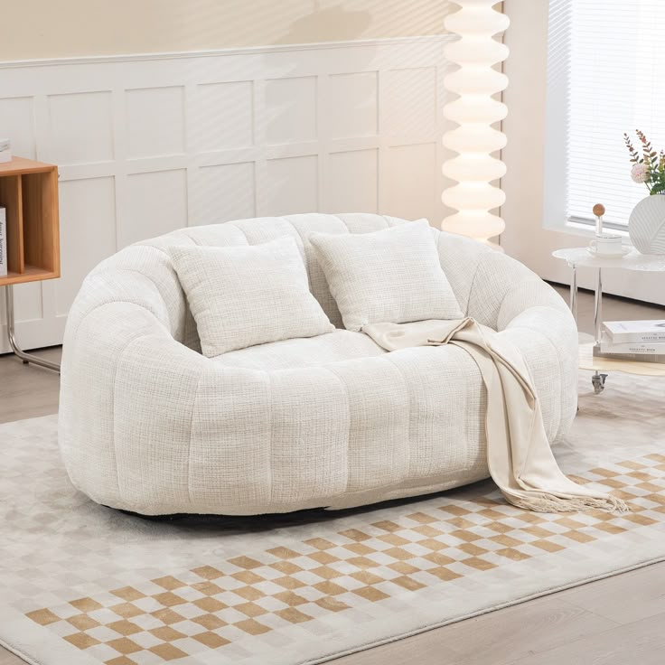 a living room with a round chair and rug