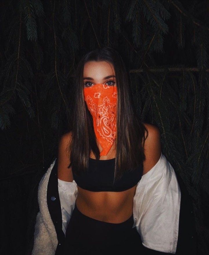 a woman with an orange mask covering her face