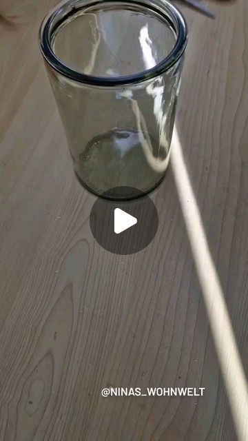 a glass cup sitting on top of a wooden table