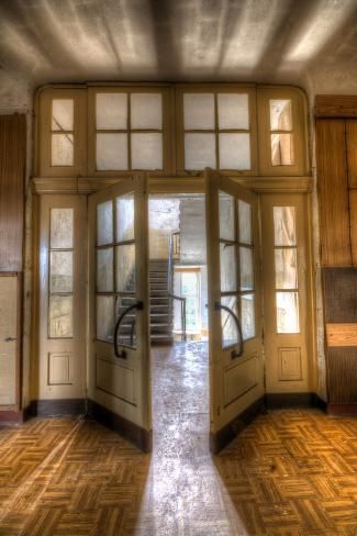 an open door leading to another room with stairs