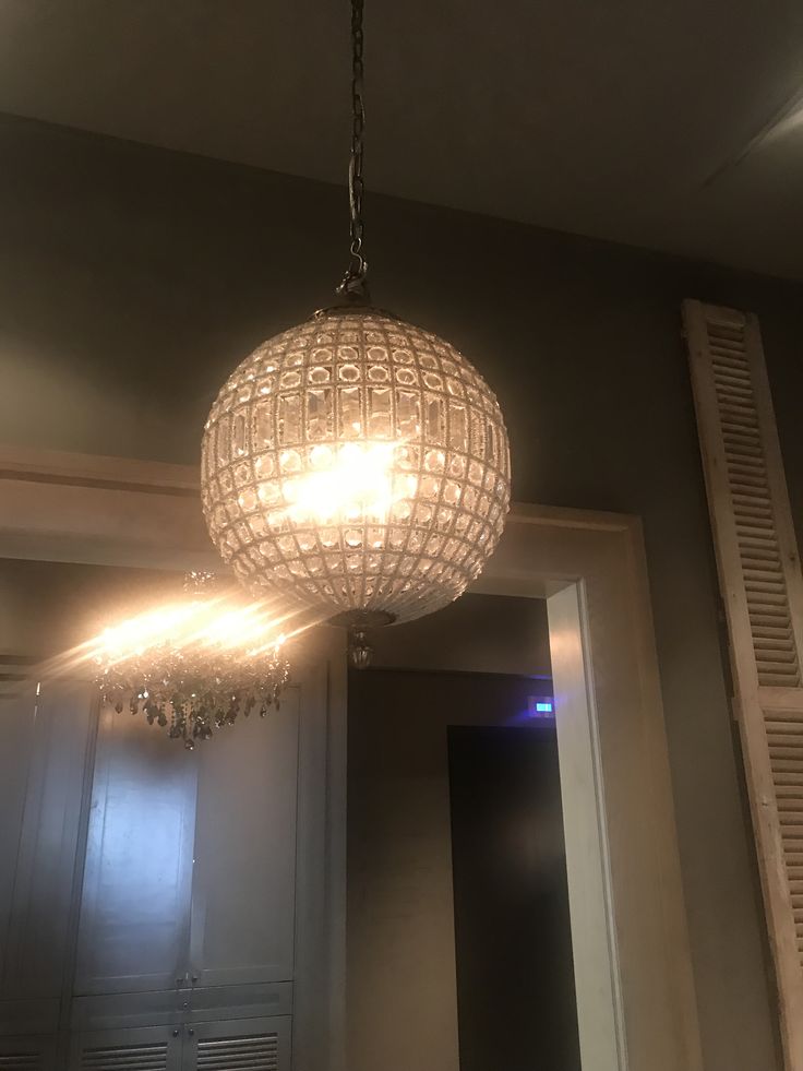 a chandelier hanging from the ceiling in a room