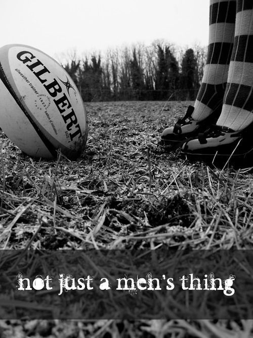 a person standing next to a rugby ball on top of a grass covered field with the words, not just a men's thing