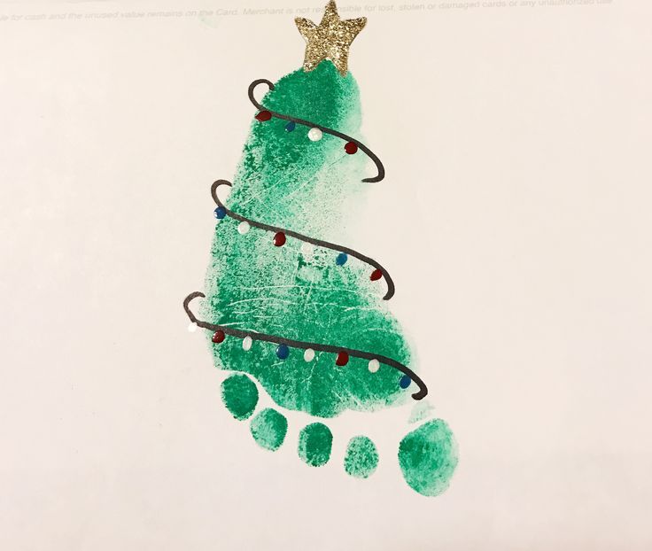 a handprinted christmas tree ornament on a piece of paper with green paint