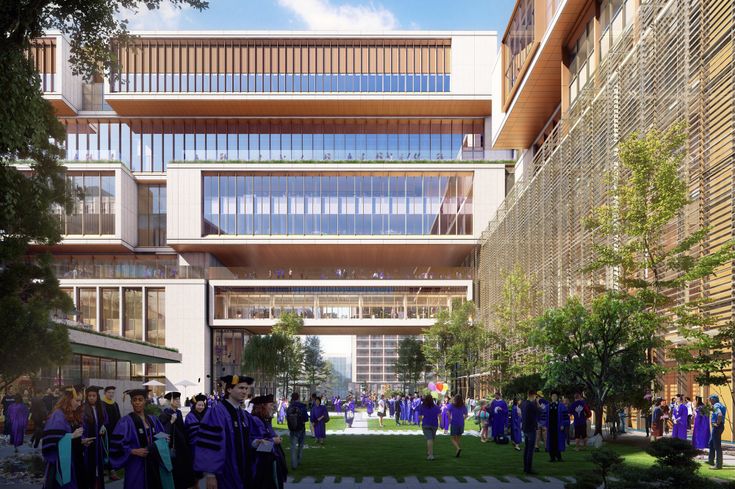 a group of people in graduation gowns are walking through a courtyard with tall buildings