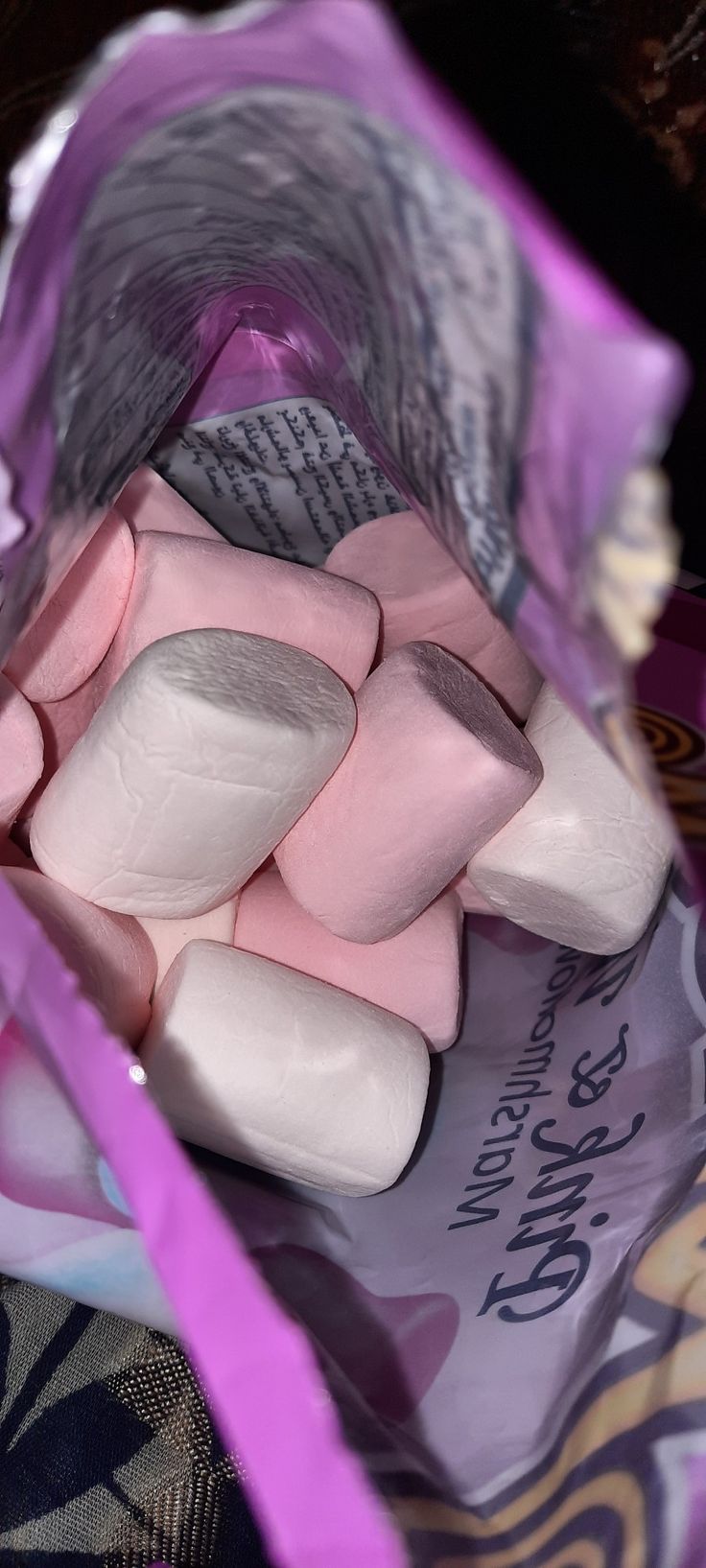 marshmallows in a purple bag sitting on top of a table