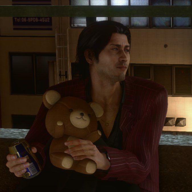 a man holding a teddy bear in his arms