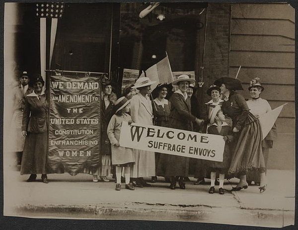 an old black and white photo shows women holding signs that read welcome surface envys