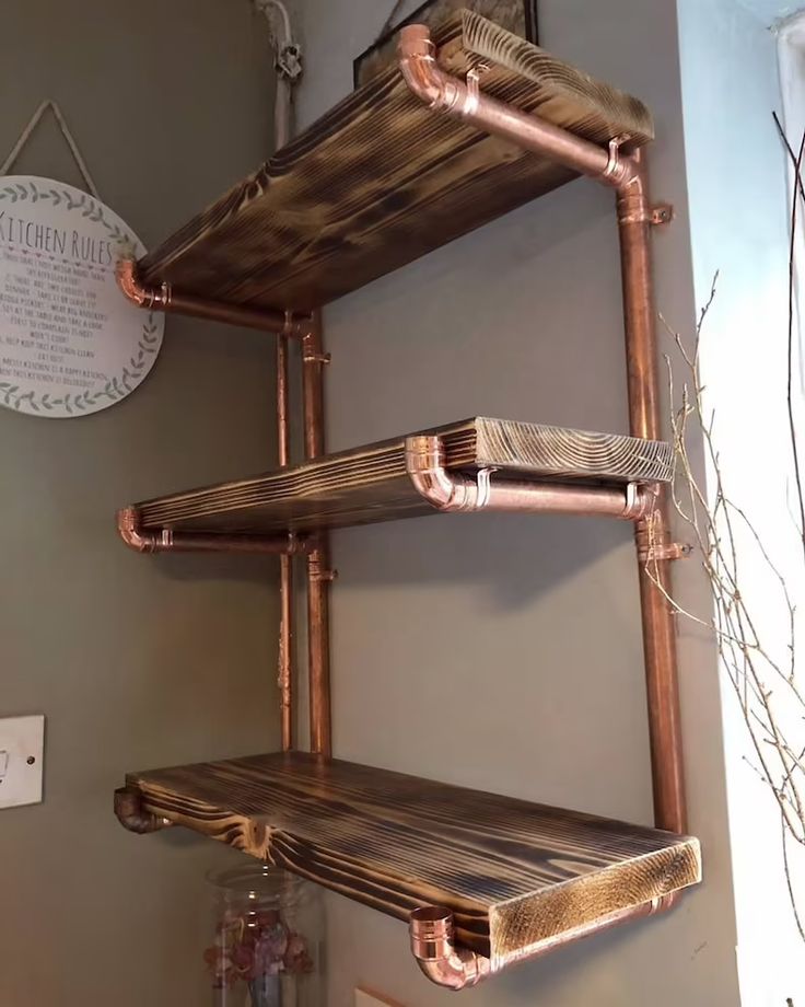 three wooden shelves on the wall in a room