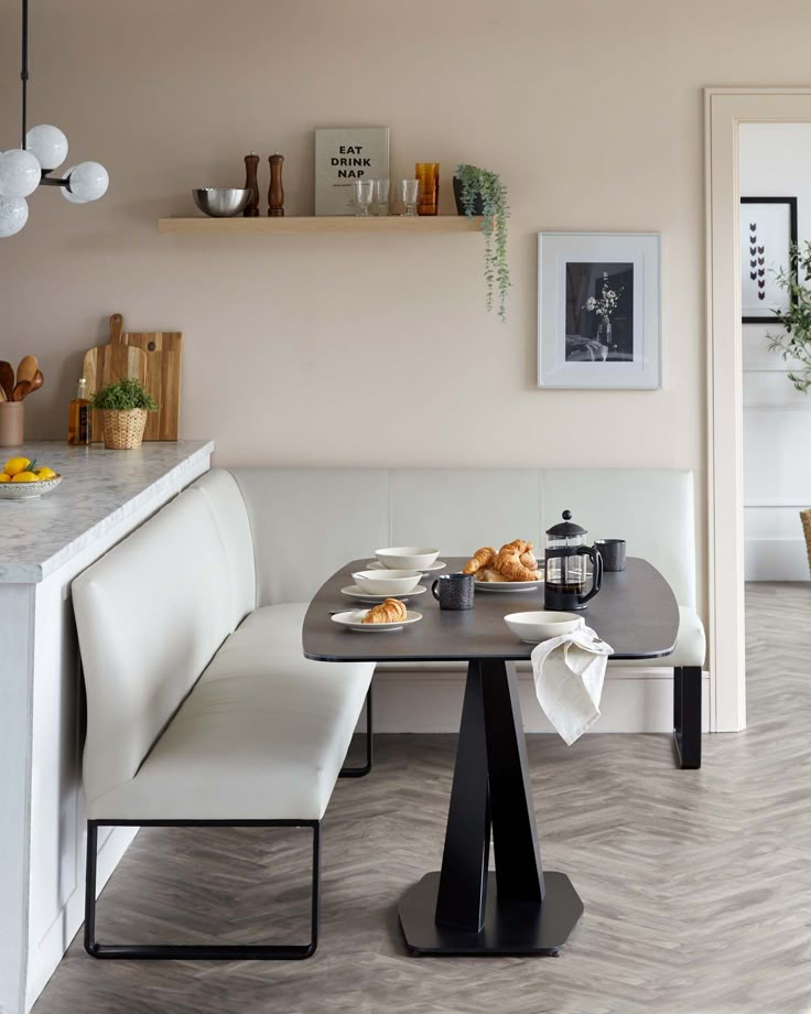 a table with some food on it in front of a wall mounted shelf and shelves