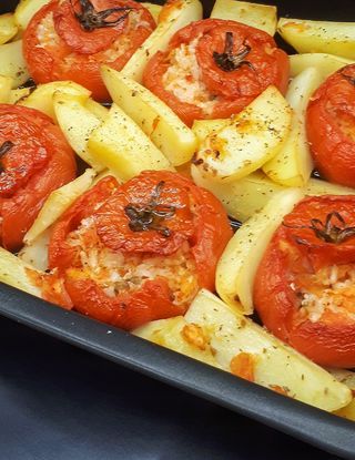 a pan filled with cooked tomatoes and potatoes