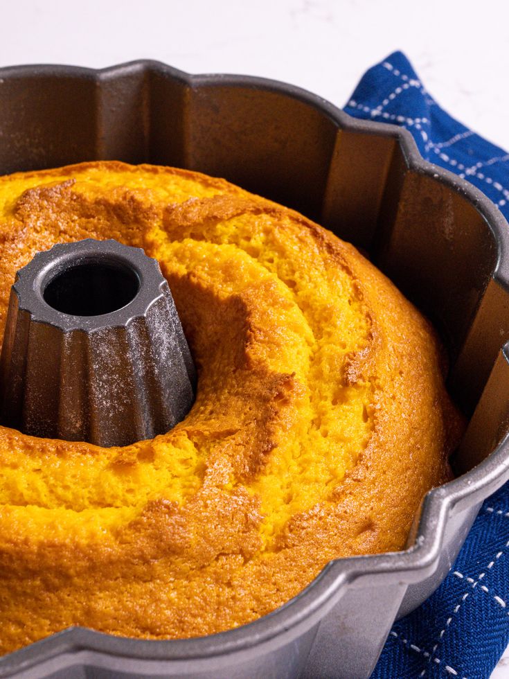 a bundt cake in a pan on a blue towel