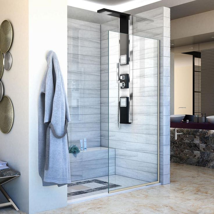 a bathroom with a walk in shower next to a bathtub and towels on the wall