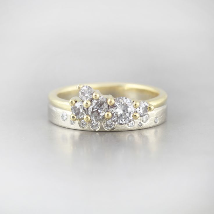 three stone diamond ring in yellow gold and white gold with two diamonds on each side