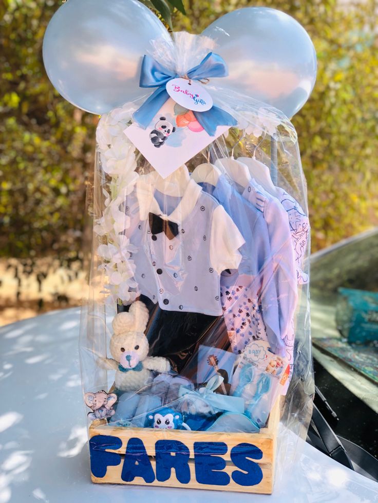 a box filled with clothes and toys on top of a table