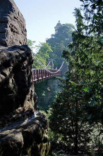 a bridge that is hanging over some rocks