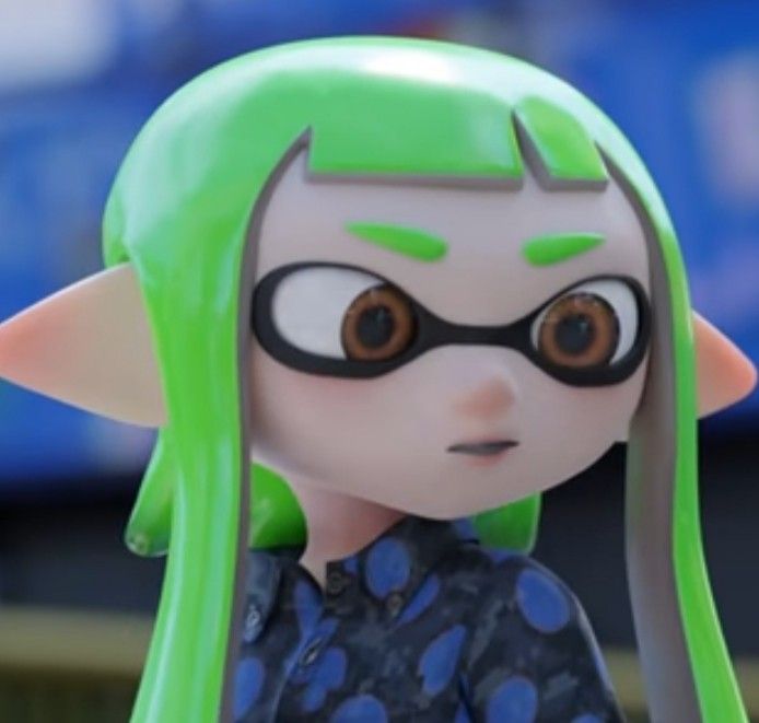 a close up of a doll with green hair and glasses on it's face