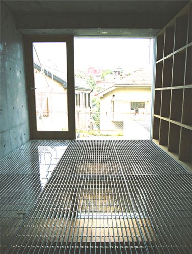 an empty room with metal grates on the floor and open doors to another room