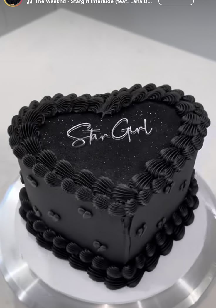 a heart shaped cake with the name shan girl written on it and stars in the background